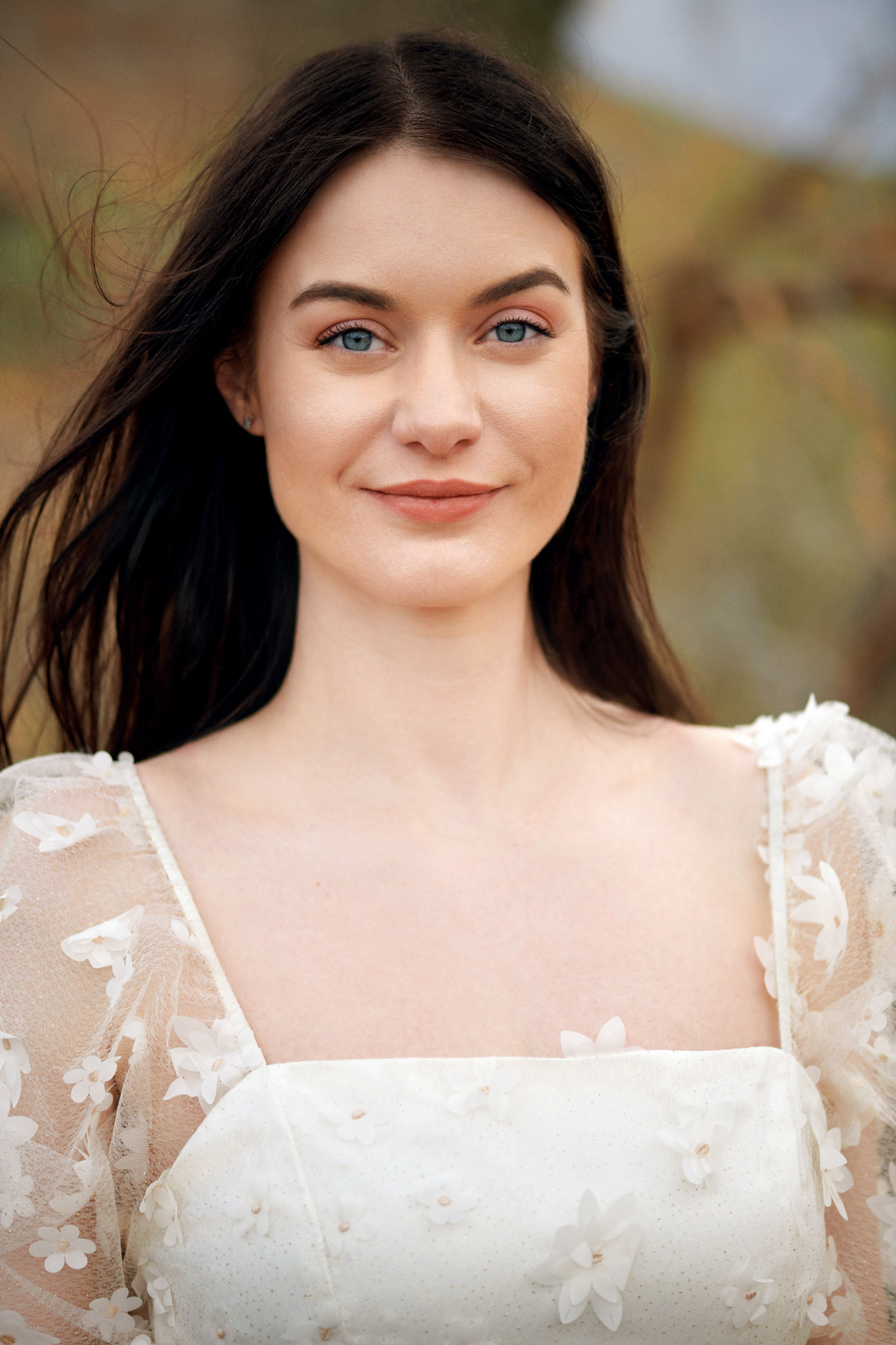 Elena Biedert portrait - friendly looking into a camera, wearing white dress