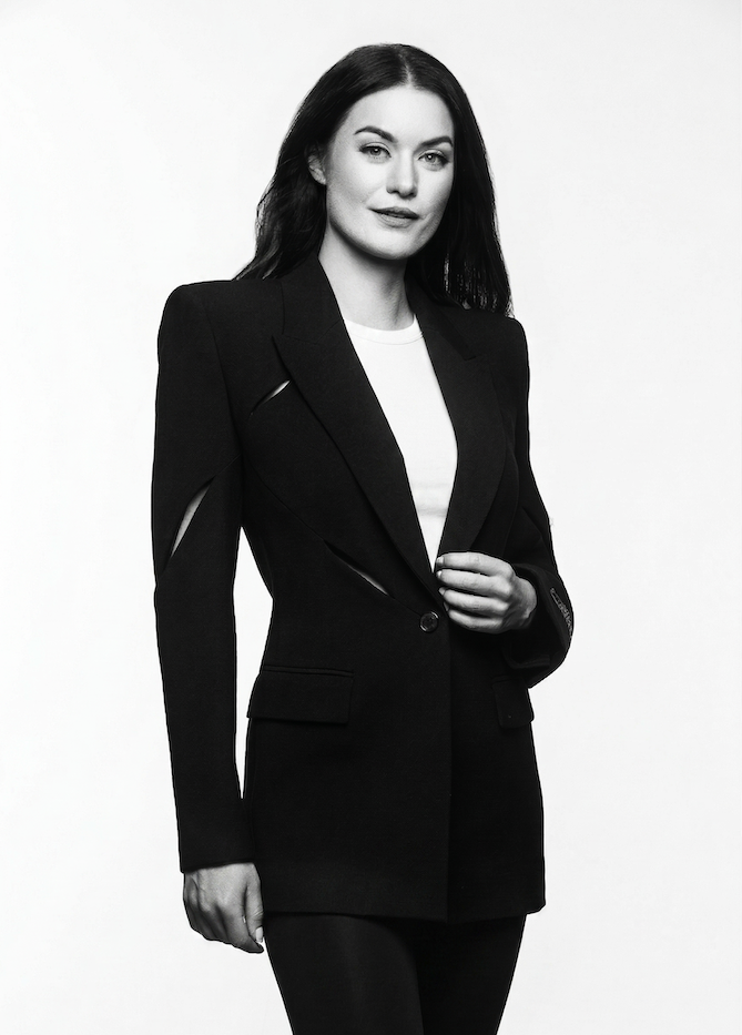 Elena Biedert Strategy Audit Portrait of Elena Biedert in Black White, wearing a black suit, looking into the camera